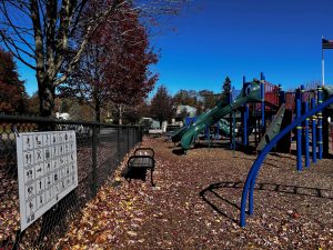 Playground with communicaion board on chainlink fence